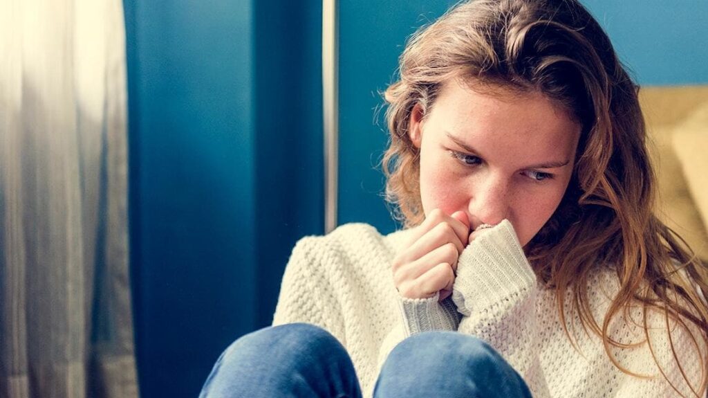 Une jeune femme complexée par son acné du visage